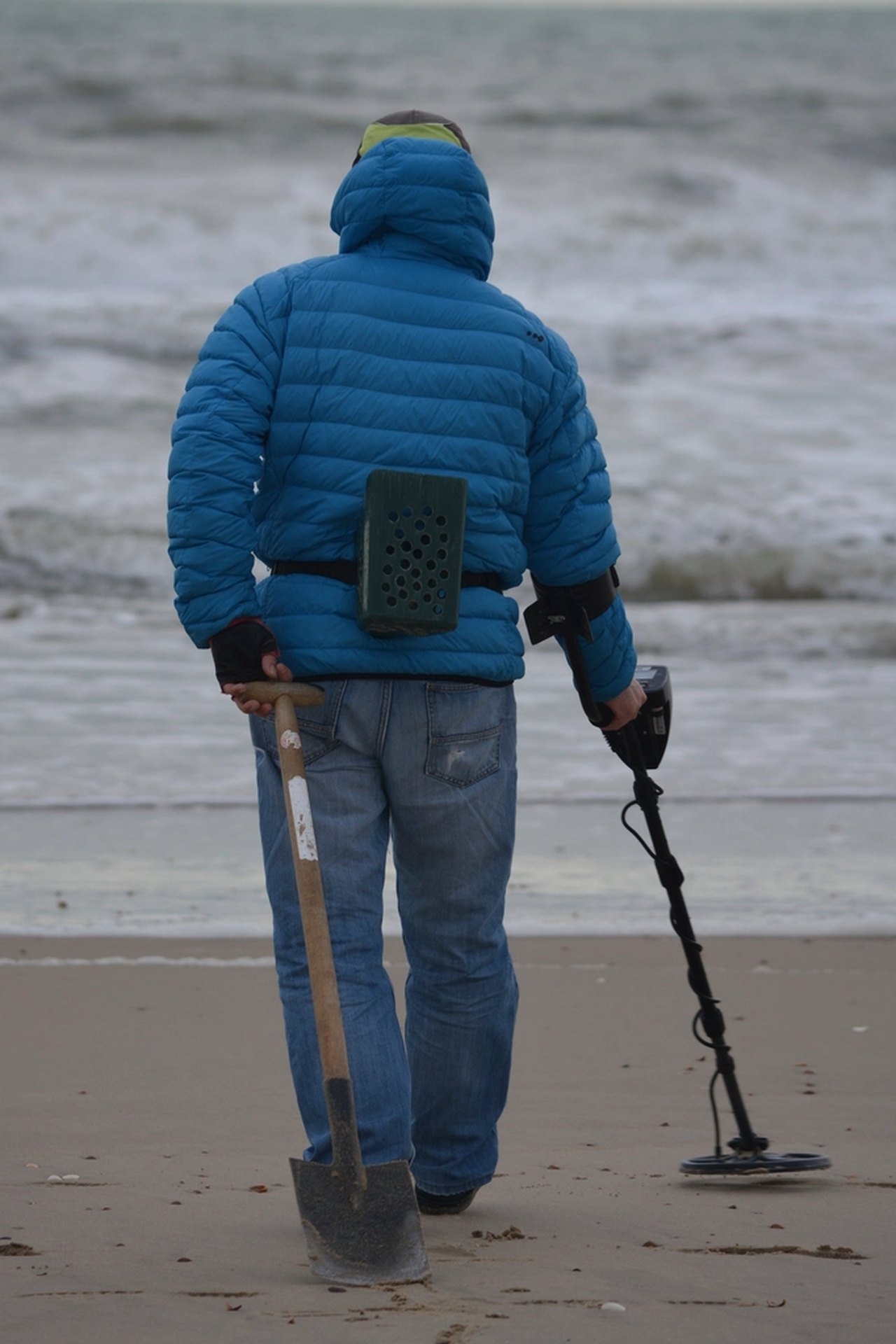 Illustration of a long-handled metal detecting sand scoop with a sifting basket
